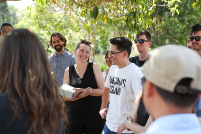 Thinkmill staff during a game of stealing santa at the 2022 Christmas party picnic